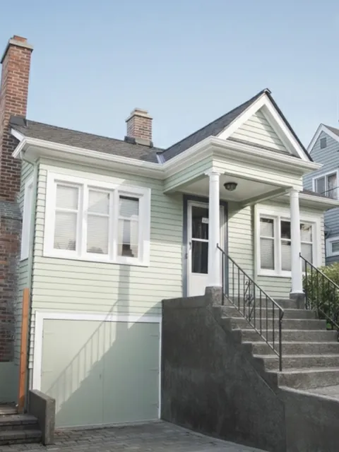 After: house painting before and after, faded siding repainted sage green
