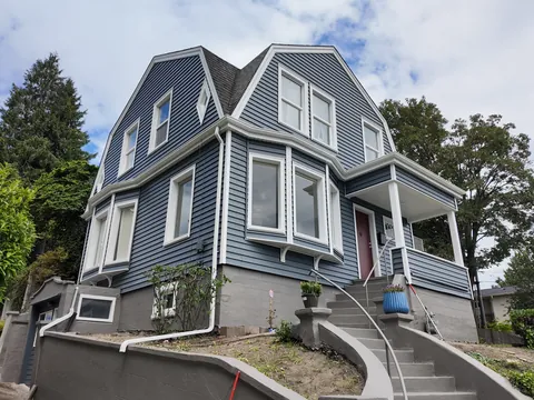 After: exterior house painters repainted a home blue with white trim