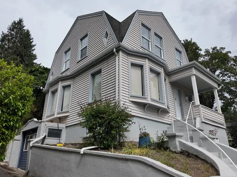 Before: exterior house painters repainted a home blue with white trim