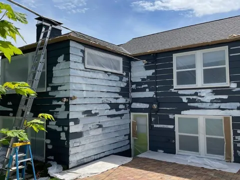 Before: peeling exterior paint scraped, primed and repainted
